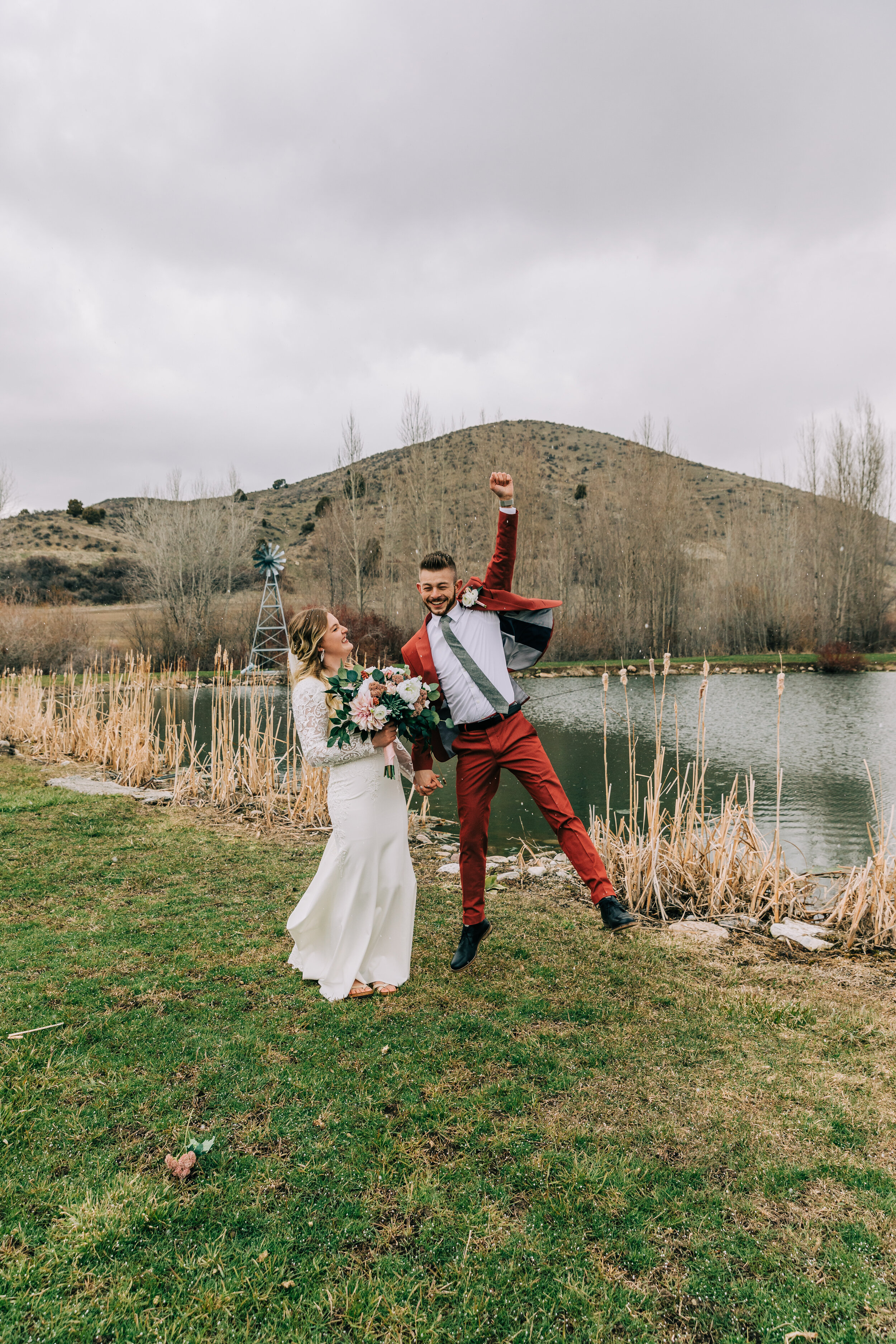  An excited groom jumping for joy by his stunning bride in a fun fall wedding. Preston, Idaho wedding elopement photographer inspiration ideas and goals for modern brides fun unique couple pose inspiration couple goals outdoor wedding inspiration out