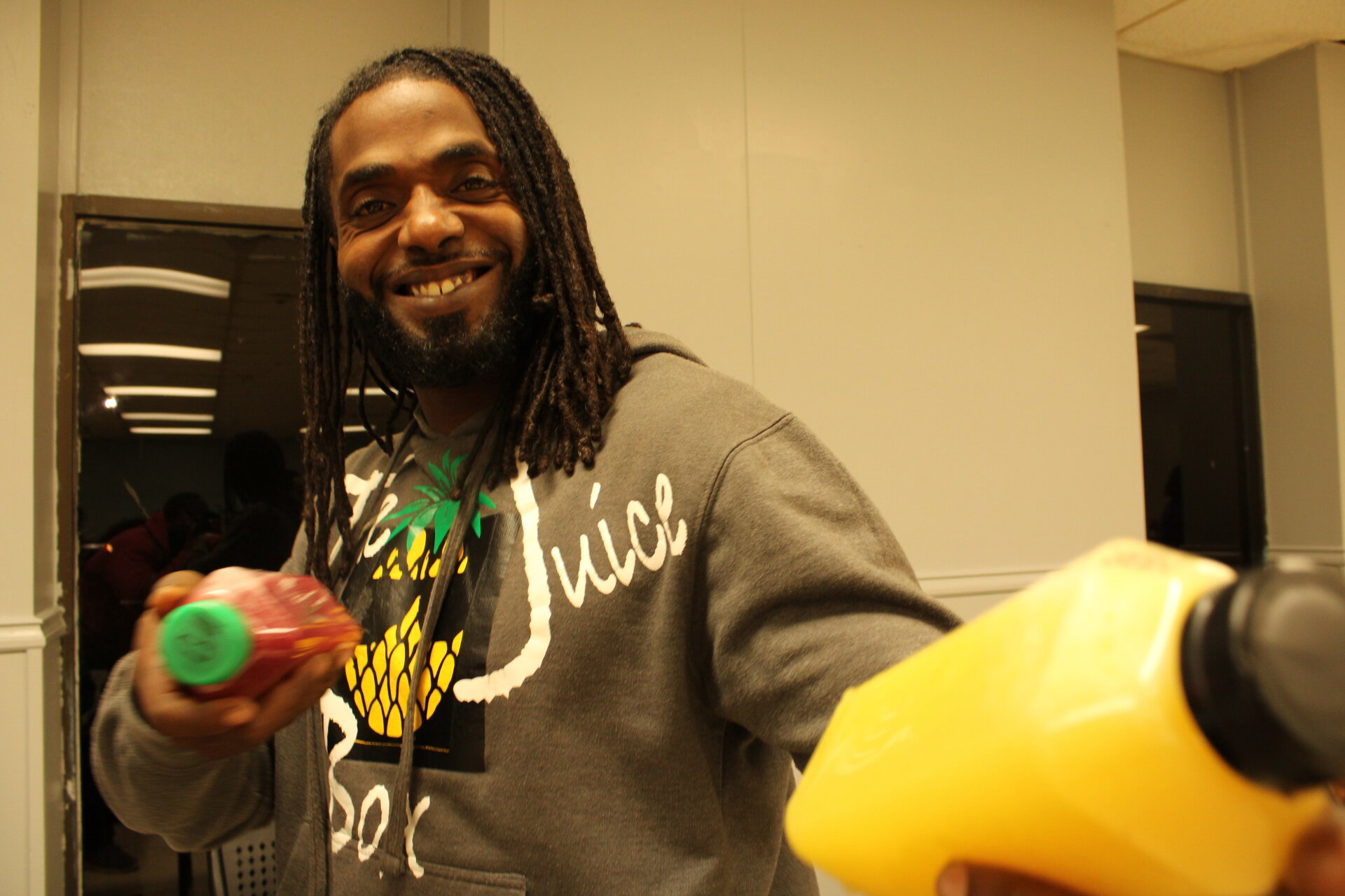 Photo of Mr. Tony of The Juice Box posing with some of his fresh pressed juice!