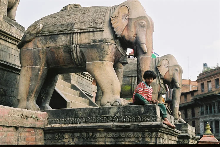 Annabel_Illingworth_Nepal_girl_by_stone_elephant.jpg