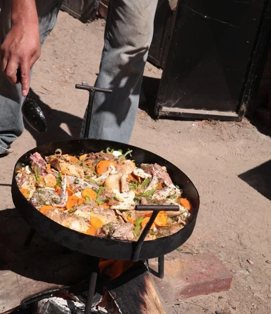 Yesterday, we invited Lalo, aka the Asado Maestro, to come over and make a specialty chicken dish for some people who were going to come to our house. He started off building the fire underneath a large outdoor stove/pan. First, he threw in onions and butter (lots). Then peppers and carrots and many different spices, some I knew, some I didn’t. Next he threw in the chicken. Then he poured in little white wine and tomato juice. Then he let it simmer for a couple of hours. I’m not sure what word to use for it, it was amazing. It had such a rich flavor. I could probably eat it at least 5 times a week. It reminded me of a book I read when I was little called Stone Soup , it would always make me so hungry when I read it.