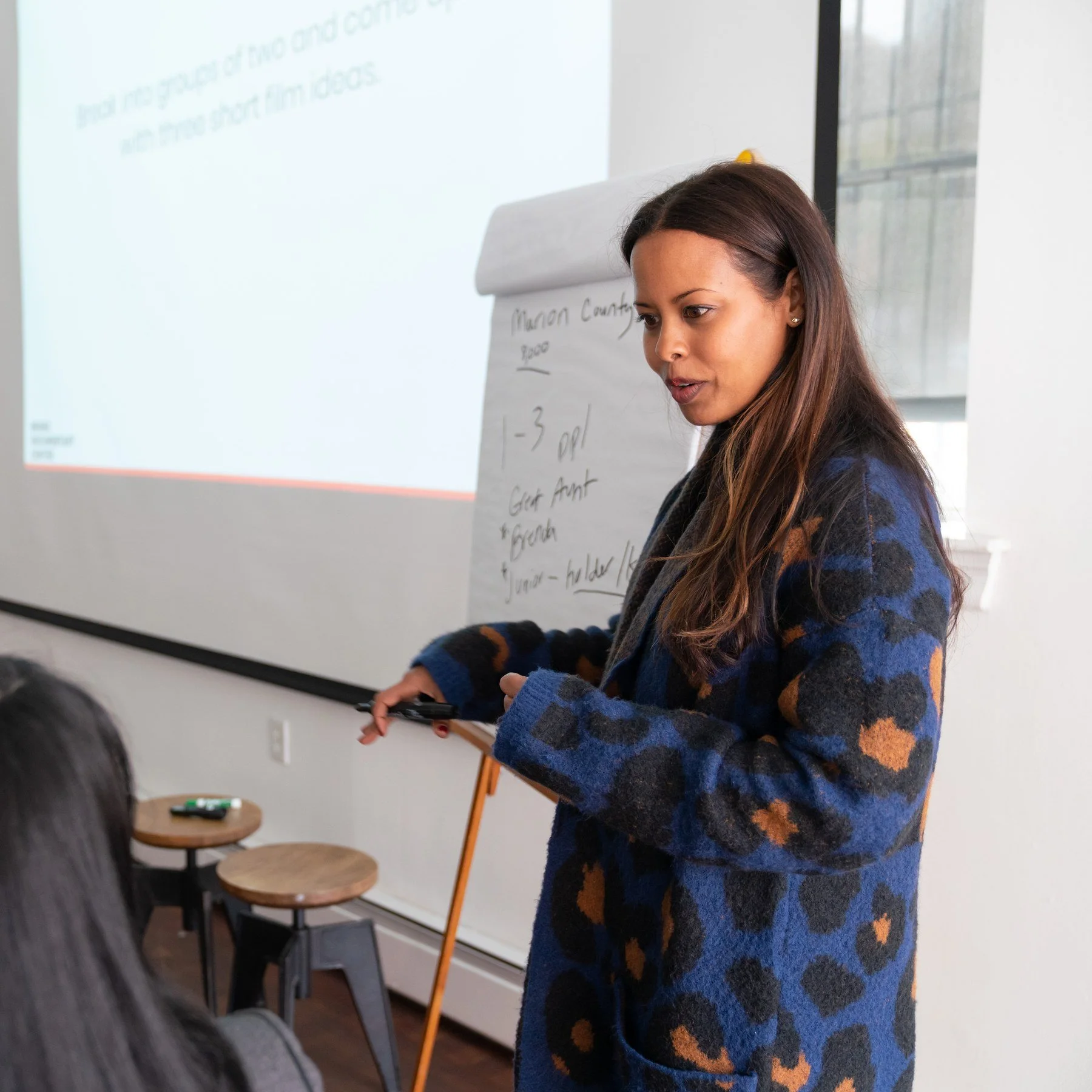 Idil Ibrahim teaching at a flip chart during a storytelling workshop at the Bronx Documentary Center