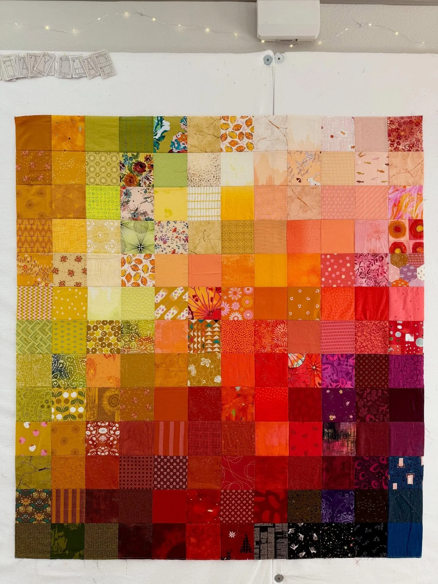 Going through scraps, playing with elements of color flow. I enjoy seeing how the colors interact with each other, and what kind of story I can tell depending on which fabrics I use. 

The construction of this one is quite basic: a grid of 5&rdquo; s