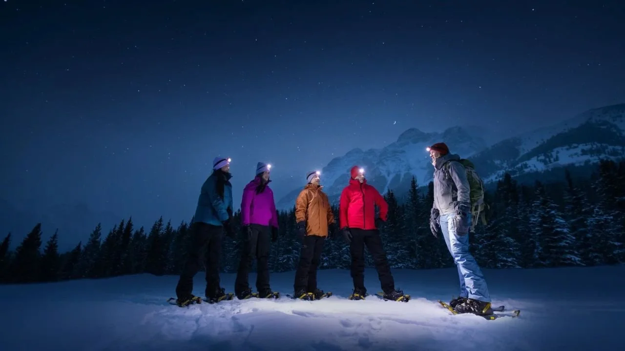 Night hiking tour from Lake Louise under starry winter skies with snow-covered trails
