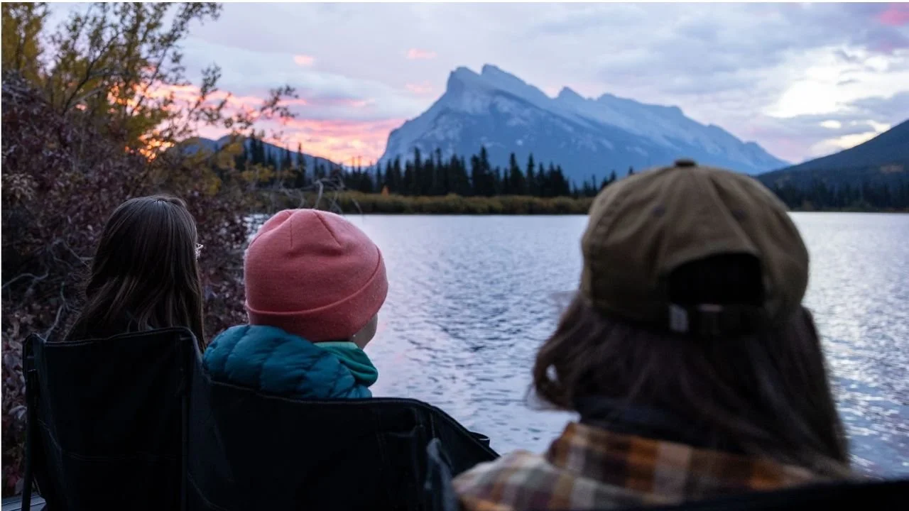 Sunrise view during Johnston Canyon hike near Banff with mountains and lake in the background.
