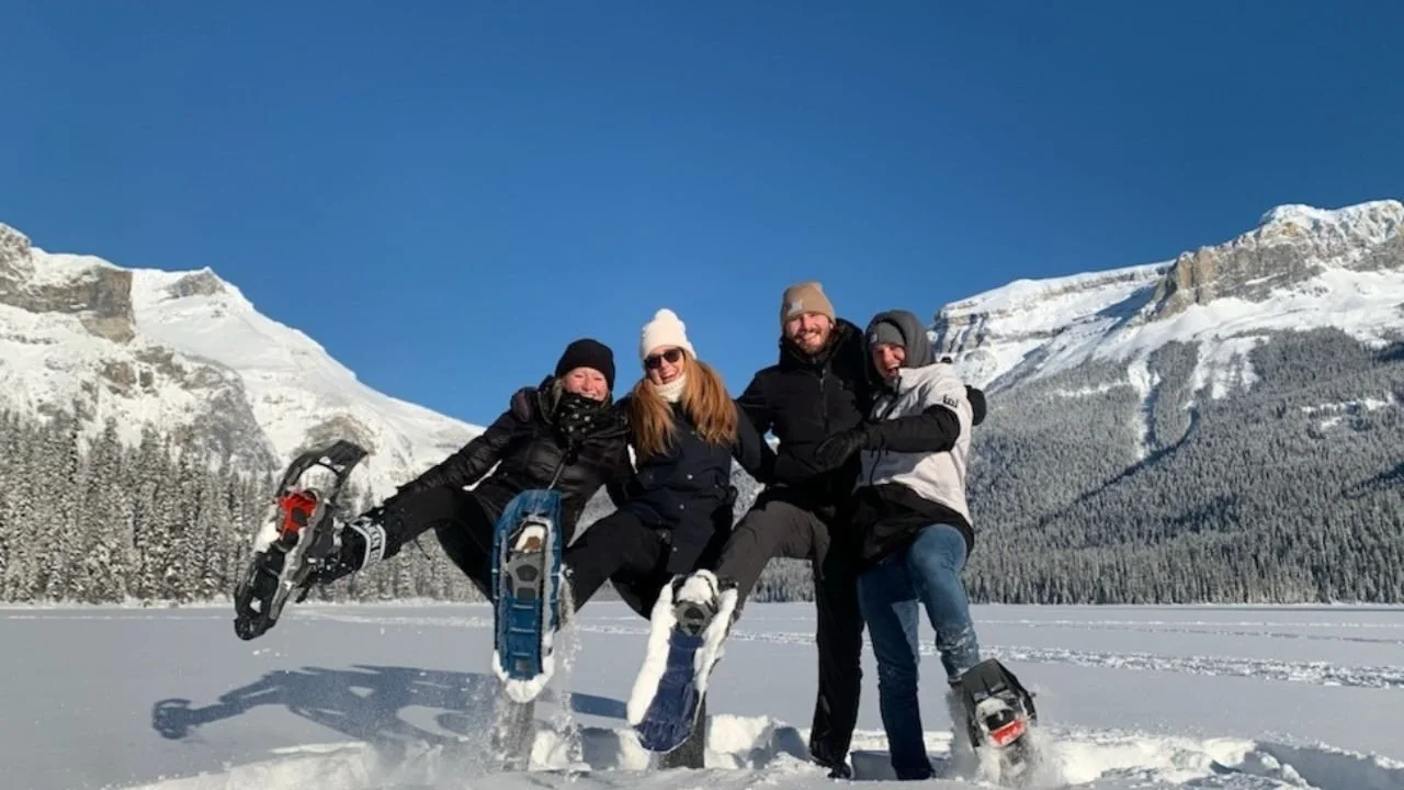 Tourists enjoying snowshoeing in the Canadian Rockies.