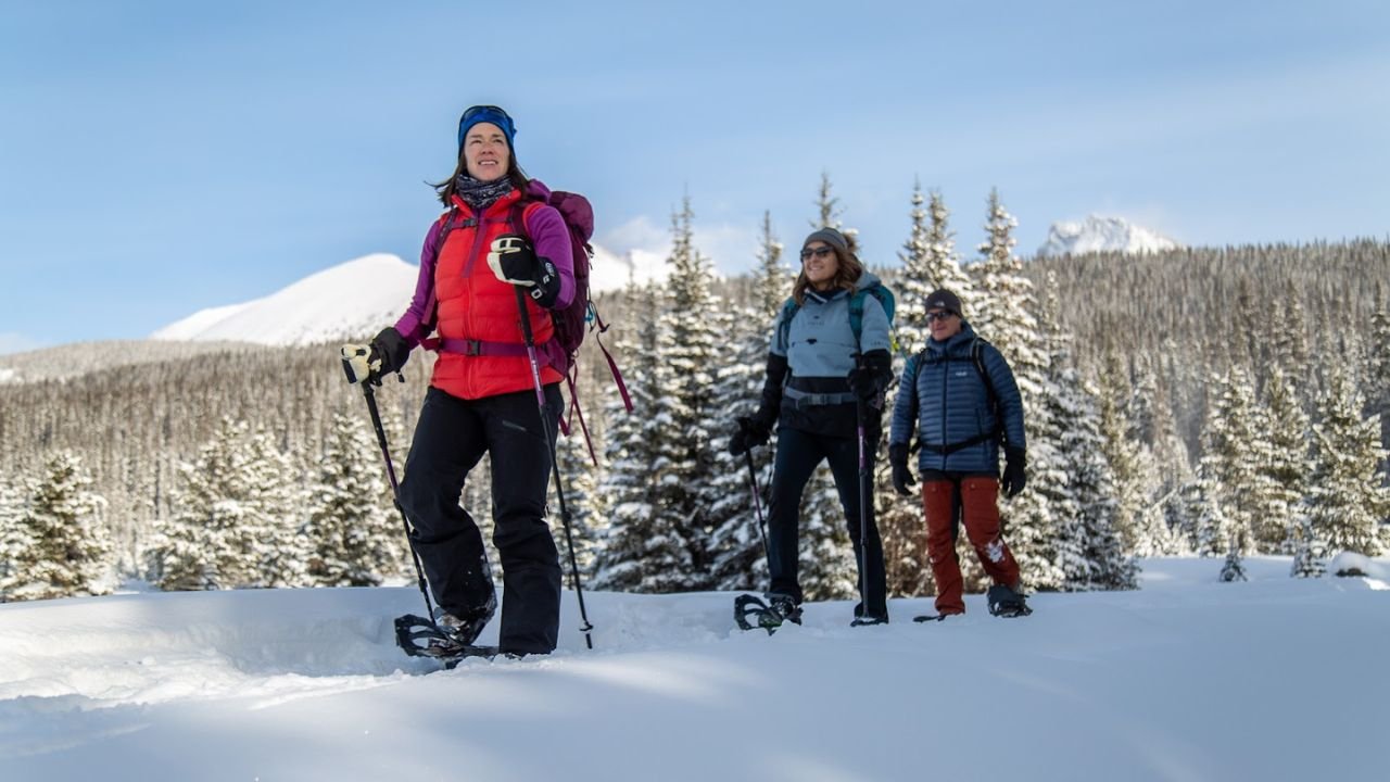 Snowshoe hikers on a winter trail from Canmore to Banff.