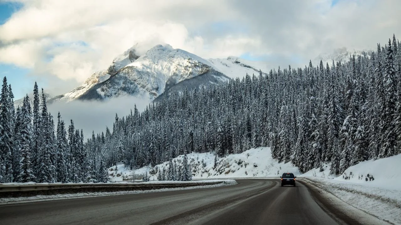 Scenic winter drive near Lake Louise with snow-covered mountains – Things to do in Lake Louise