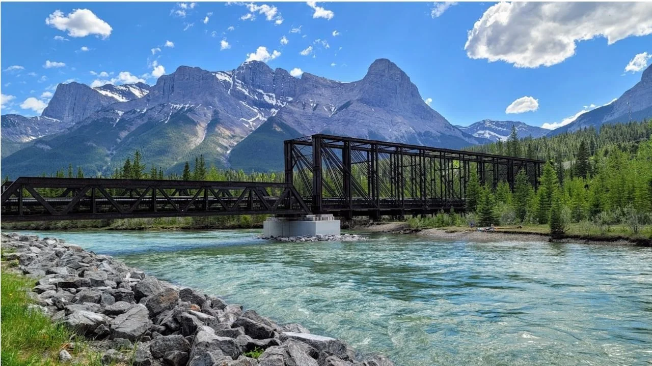 Engine Bridge in Canmore over Bow River with Rocky Mountains in the background.
