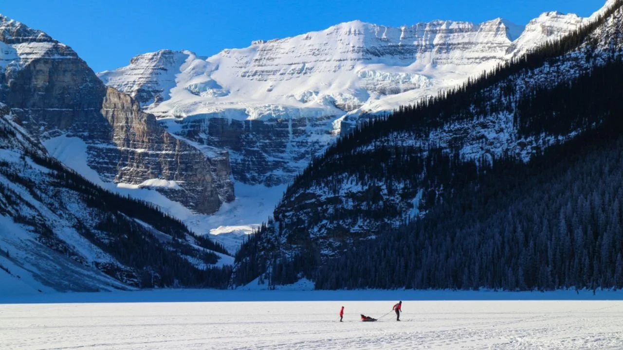 Snow-covered Lake Louise with mountain backdrop near Lake Louise Gondola in winter.