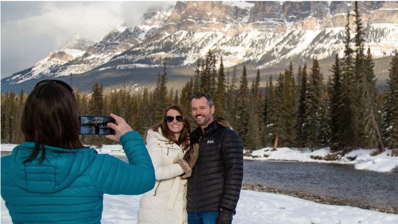 Visitors clicking photographs at Lake Louise in winter.