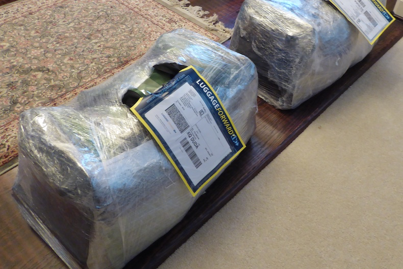 Our two large bags are wrapped in plastic with Luggage Forward labels attached