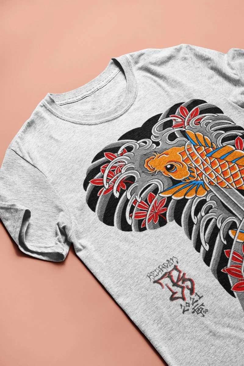 John Reardon t-shirt with koi fish print in a ash color laying flat on a salmon-colored background.