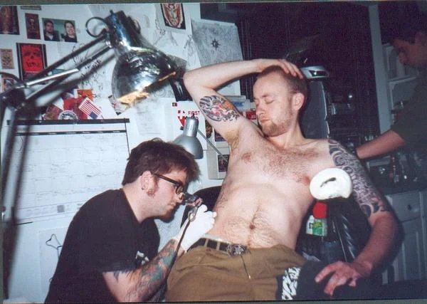 Tattooing Much in 2002. Billy in the background.