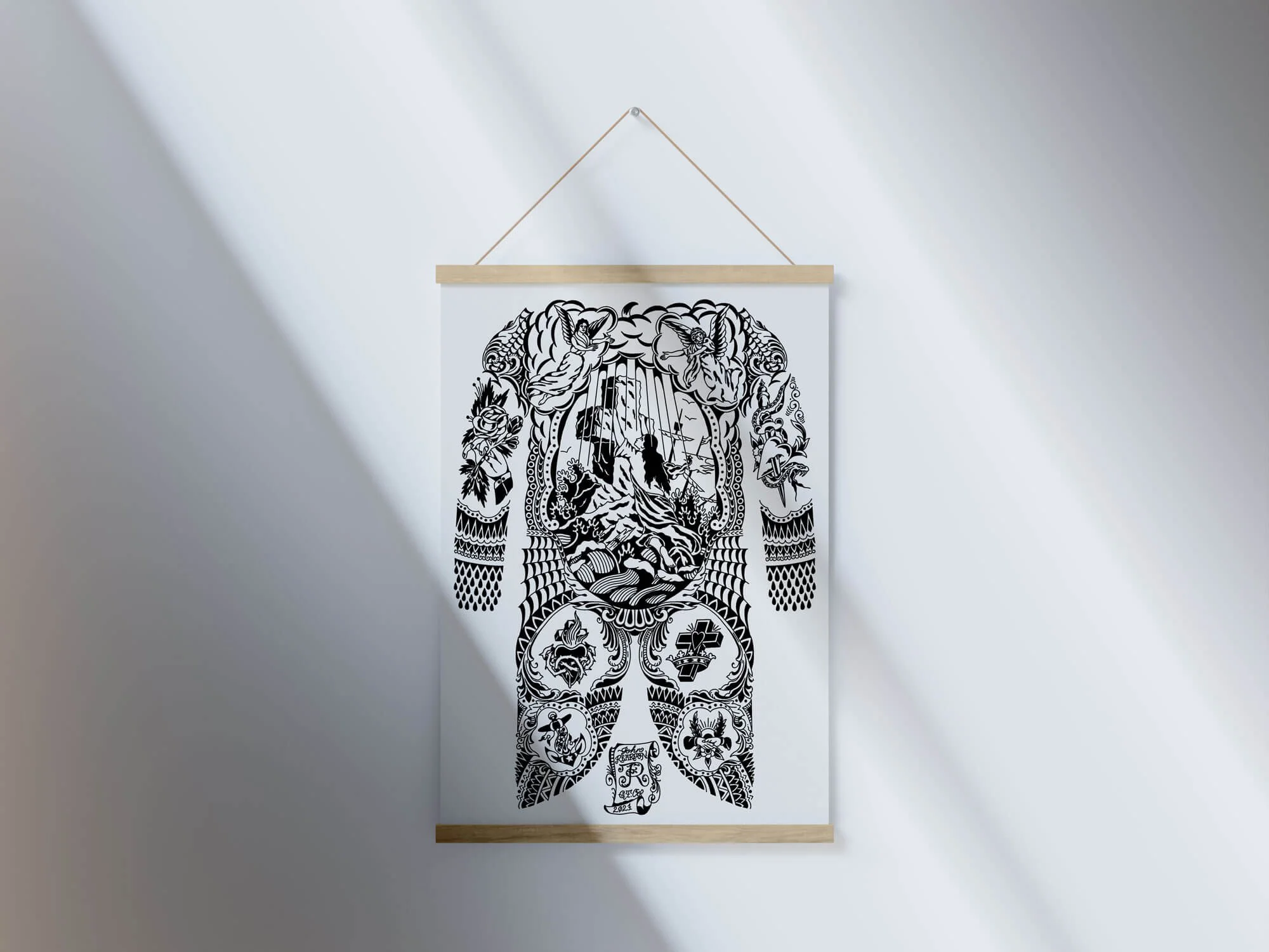 Black and white tattoo print hanging on magnetic wooden strips and chord on white naturally lit wall.