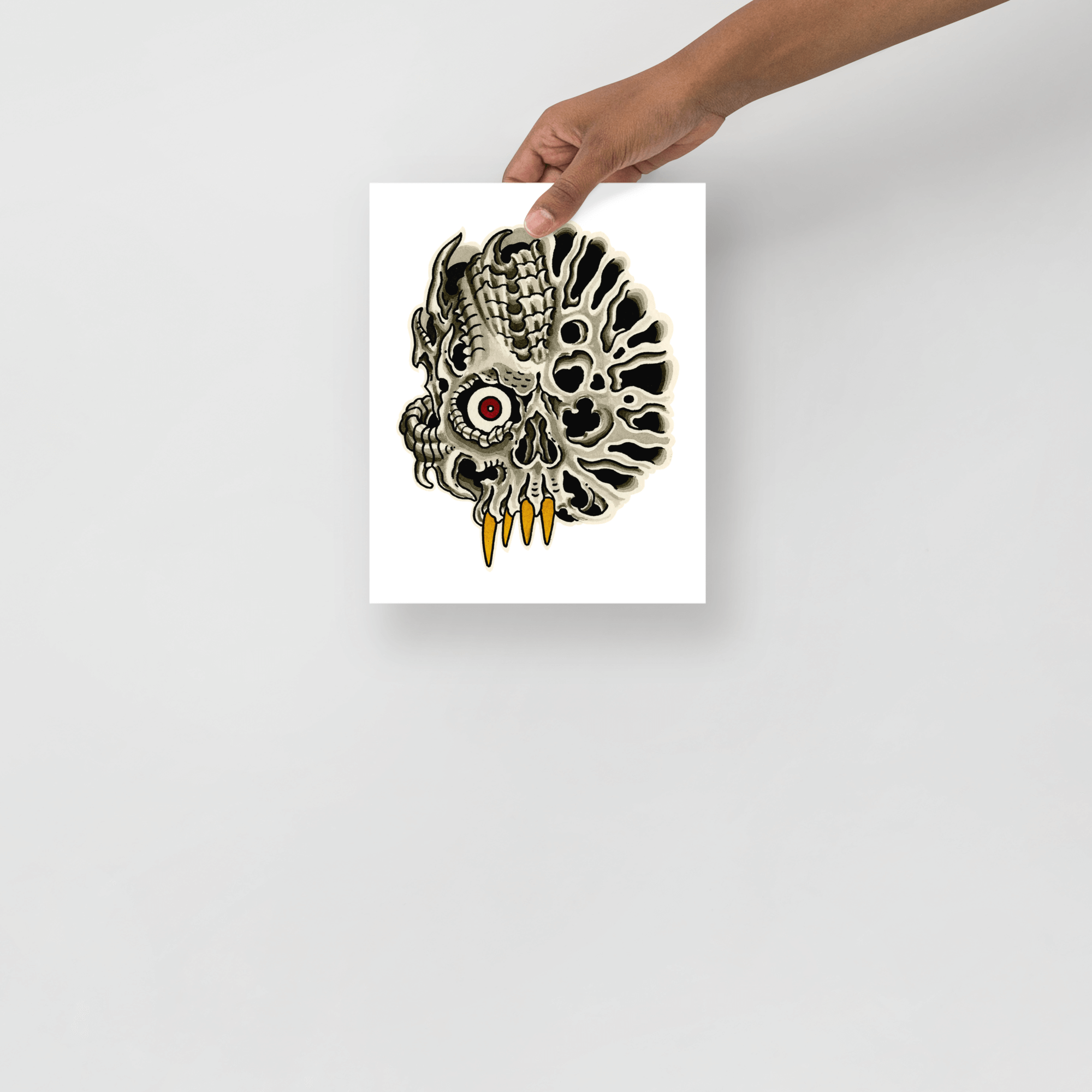 Small 8x10 prnt being held in front of a white wall.