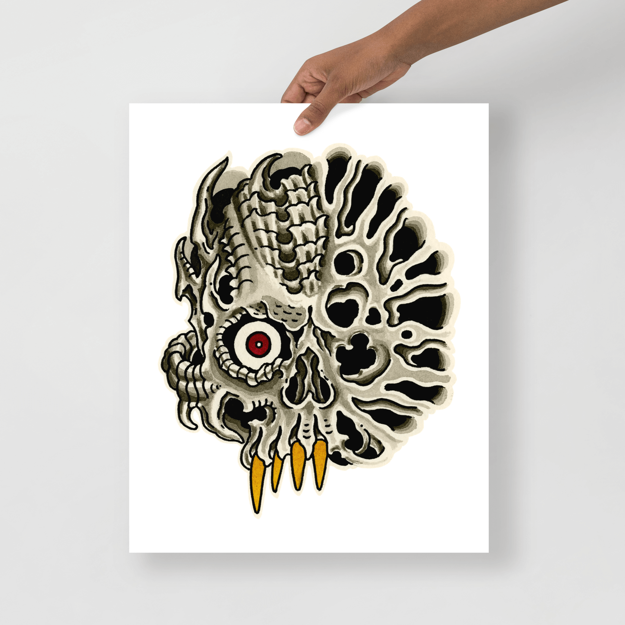 16x20 color print of a biomech skull on white background held by model.