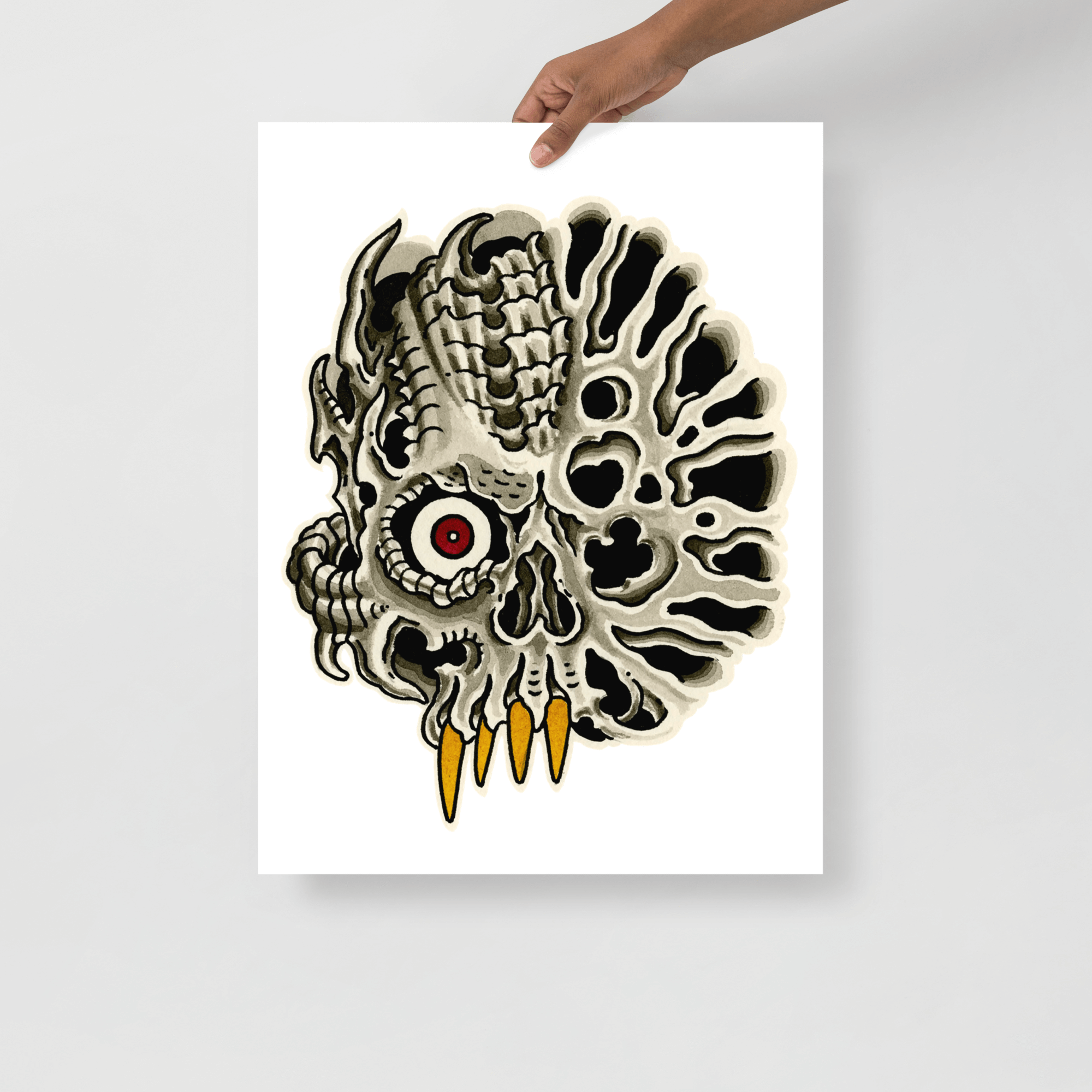 Biomechanical skull painting in print being held in front of white wall.
