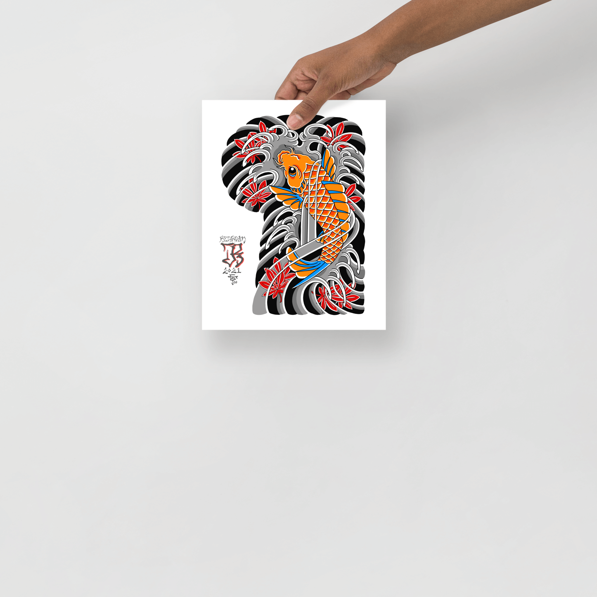 Small 8x10 print of a Japanese koi fish and maple leaves tattoo design held by model