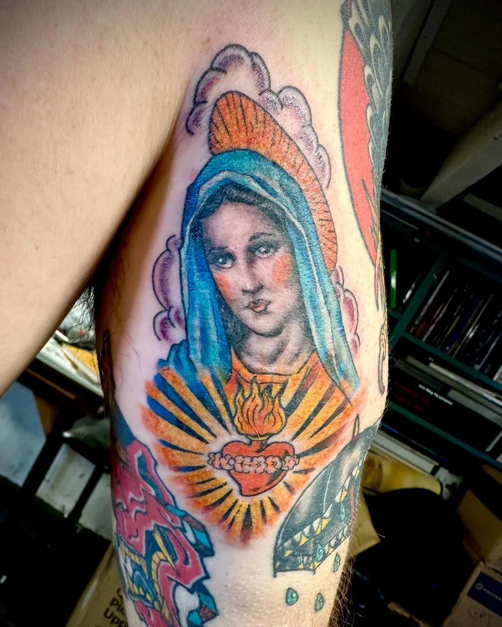 Virgin Mary tattoo in color on the back f-the-upper-arm by John Reardon in Greenpoint, NY.