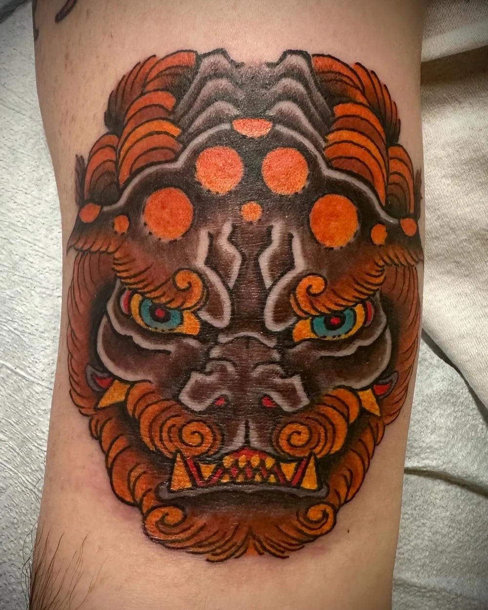 Color foo dog tattoo on the knee done in Greenpoint Brooklyn.