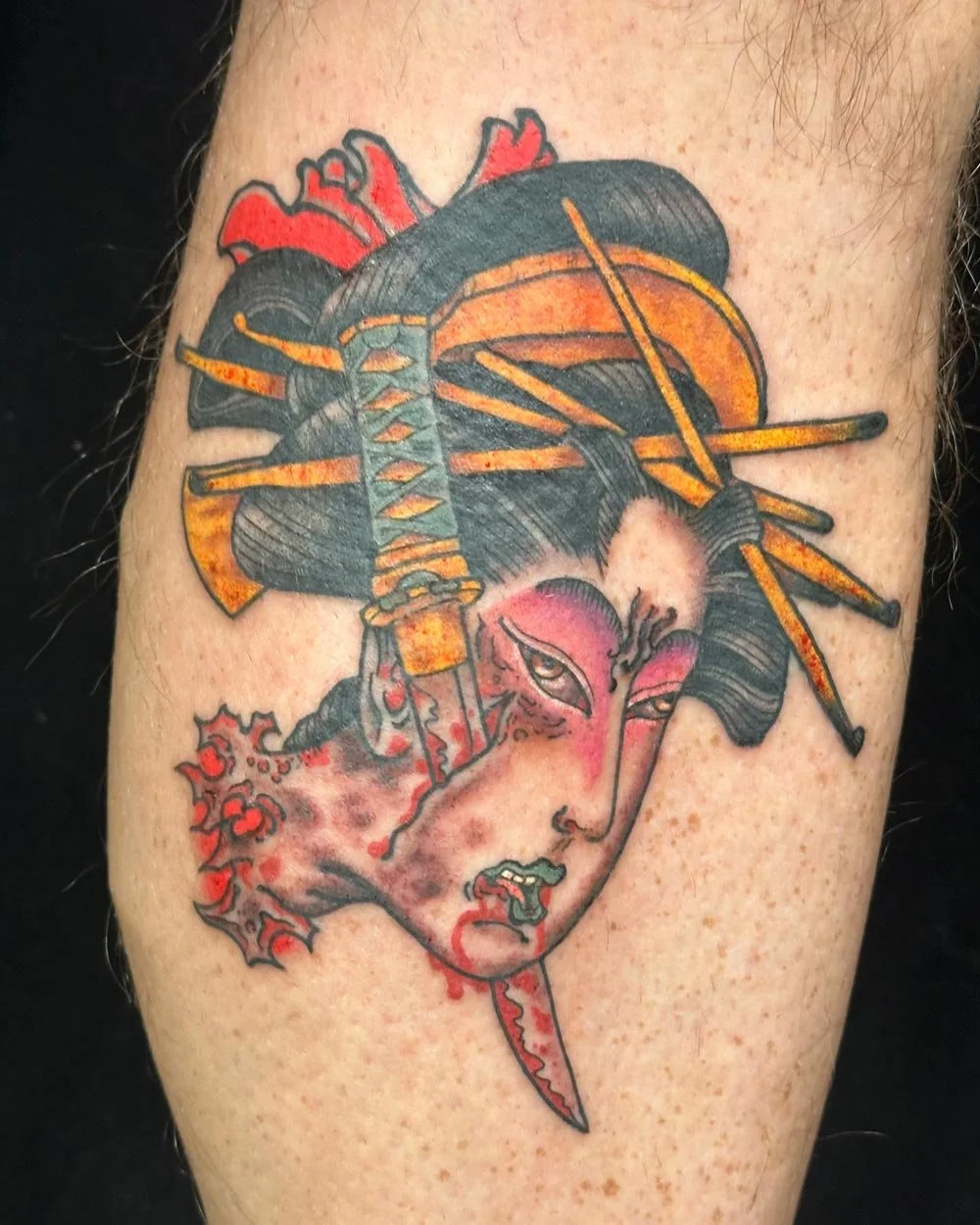 Color tattoo of a Geisha with a sword going hrough her face tattooed in NYC.