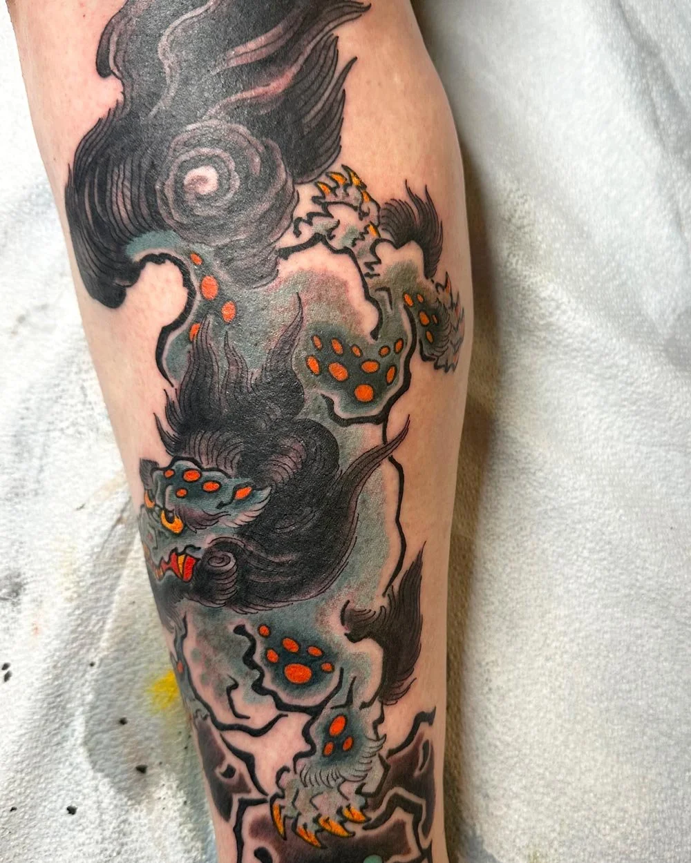 Side view of John Reardon Foo Dog tattoo in color.