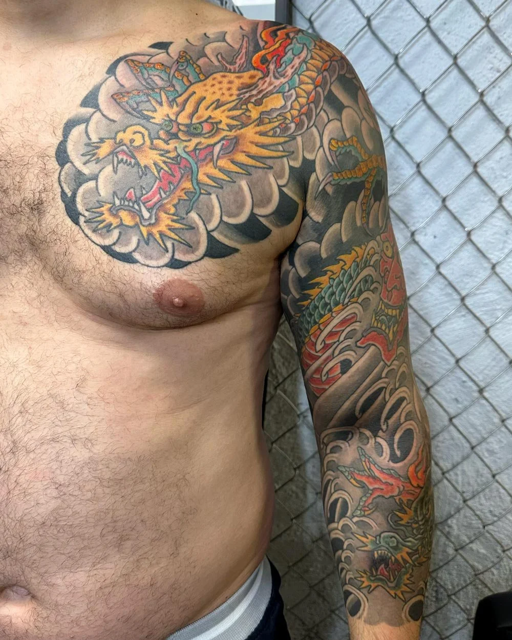 Full sleeve tattoo in color of NYC tattoo artist John Reardon.