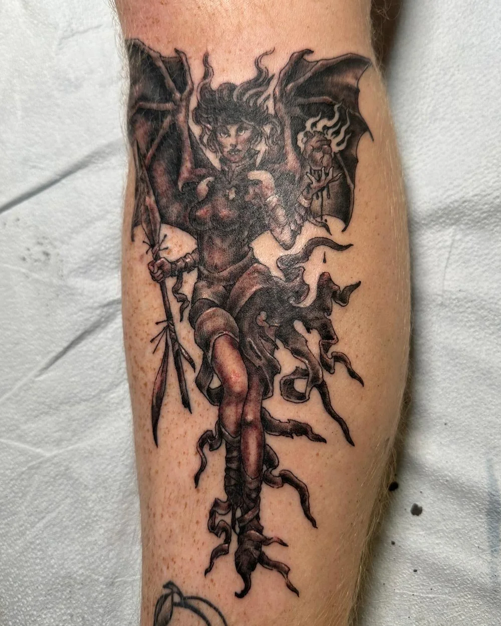 Black and grey fairy tattoo on lower leg by artist John Reardon done at the Greenpoint Tattoo shop.