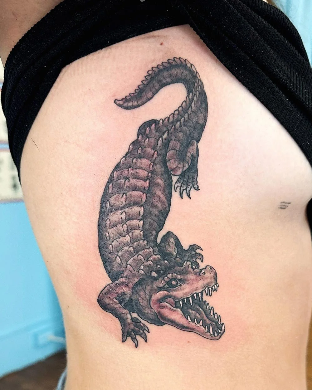 Crocodile tattoo in black and grey on the ribs tattooed in Upstate NY.