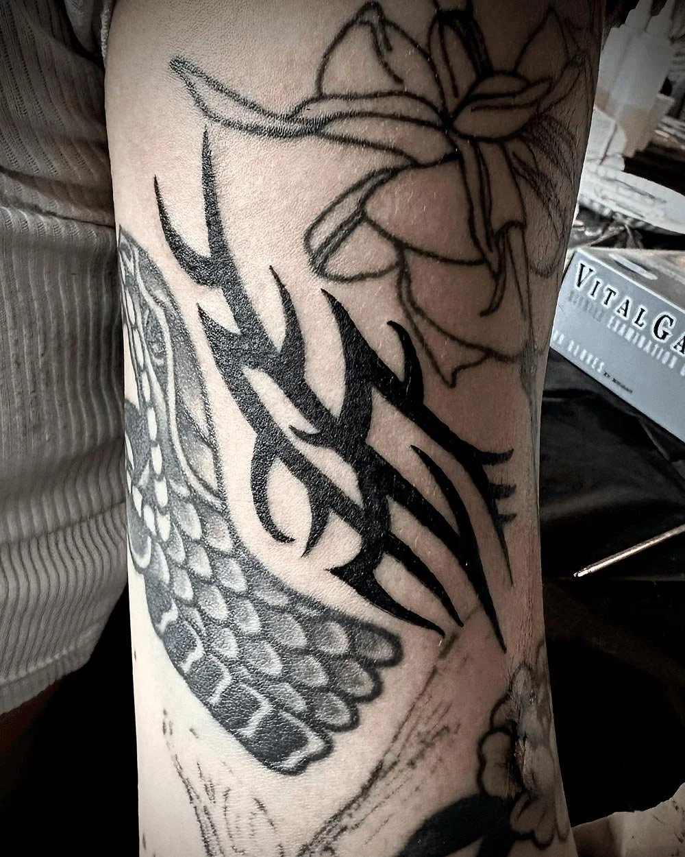 Black work tattoo of a drawn on tattoo filler.