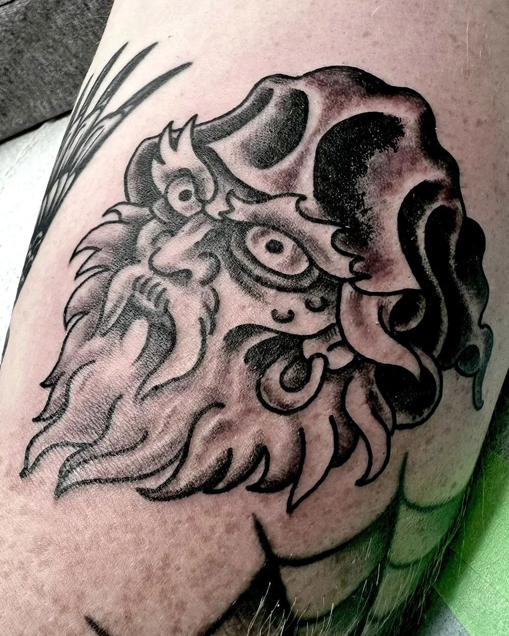 Black and grey traditional tattoo of a wizard head done by John Reardon.
