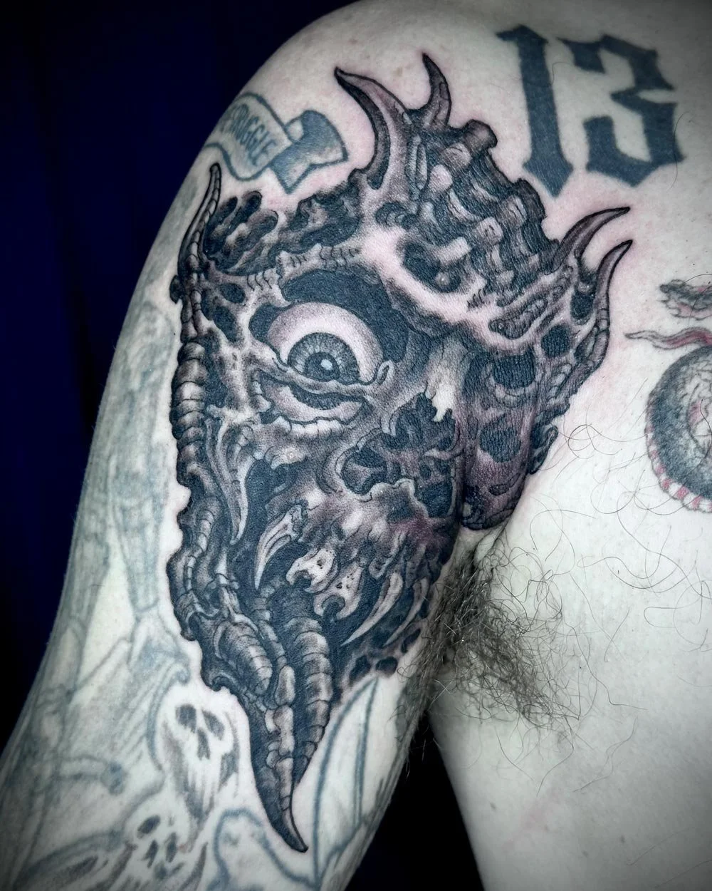 Black and grey biomechanical skull on shoulder done in NYC.