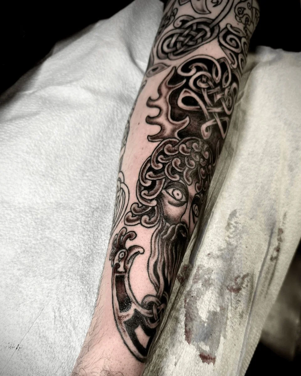 Side-view of the mythology sleeve with differrent elements tattooed by John Reardon.