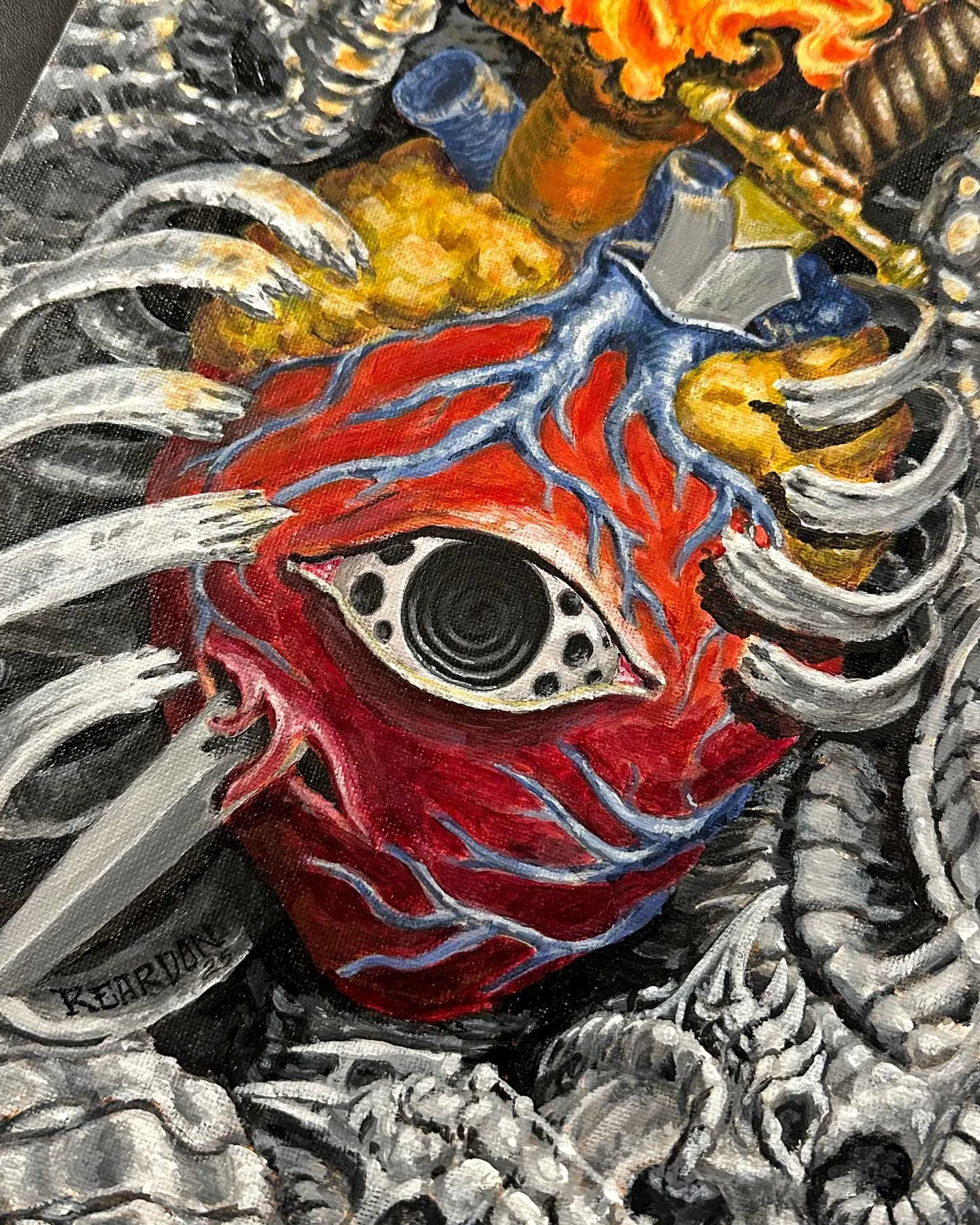 Close-up view of an original John Reardon flaming heart with biomech details.