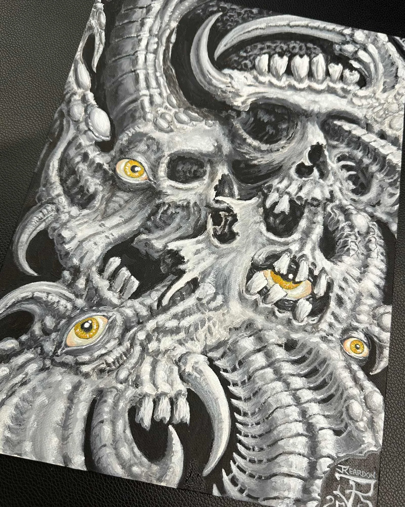 Unique acrylic on board painting by tattooer John Reardon of biomech skulls with yellow eyes.