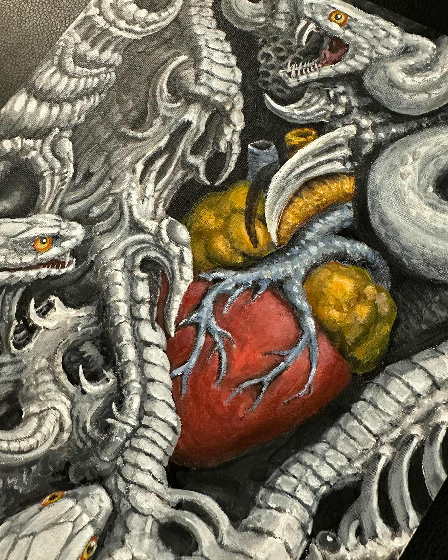 Detailed shot of an original tattoo artist painting showing a heart and snake.