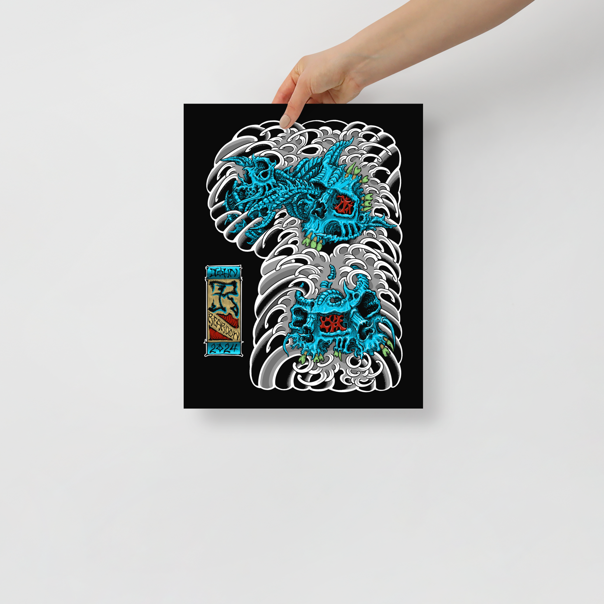Model holding the 11x14-sized print by John Reardon of blue biomech skulls on waves.