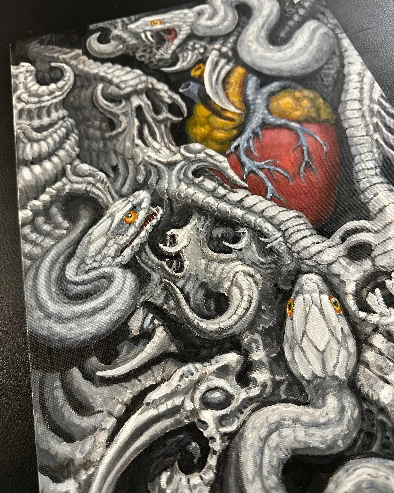 Unique black, yellow, and red original painting by John Reardon of bio-mech snakes and heart.