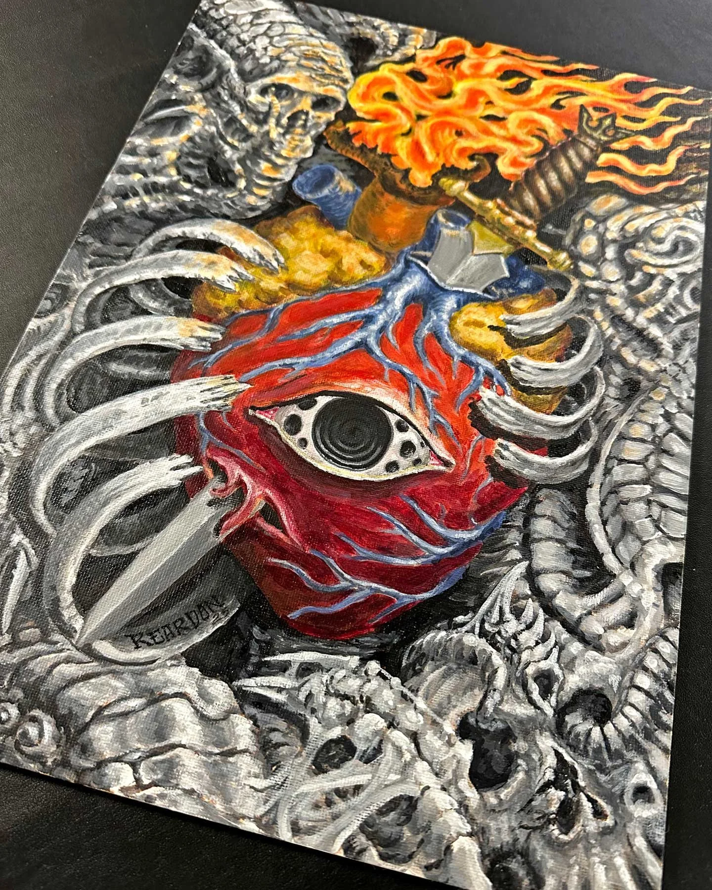 Original biomech painting in both color and black and grey of a flaming heart being stabbed inside a biomech chest.