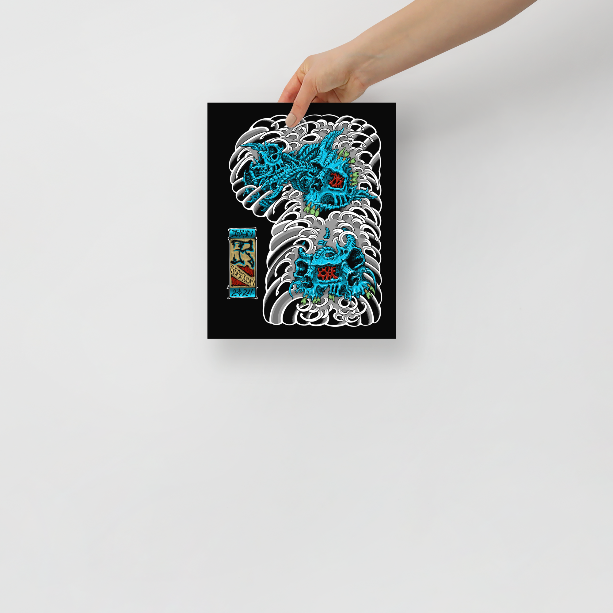 Model holding 8x10 John Reardon print of blue biomech skulls