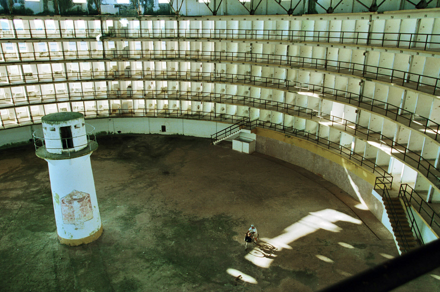  The prison cells of the Presidio Modelo, a prison at the Isle of Youth, where Fidel Castro was imprisoned after his 1953 attack on the Monacada barracks. World globetrotter German Heinz Stücke with his bike.                  