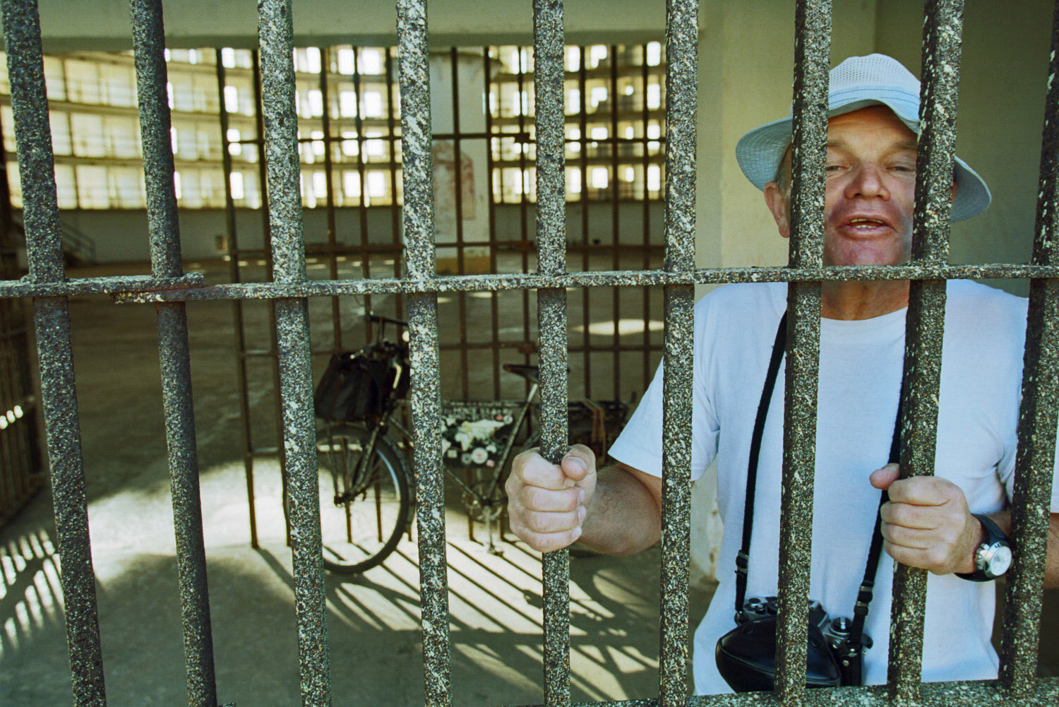  World globetrotter German Heinz Stücke with his bike jokingly inside a prison cells of the Presidio Modelo, a prison at the Isle of Youth, where Fidel Castro was imprisoned after his 1953 attack on the Monacada barracks.                  