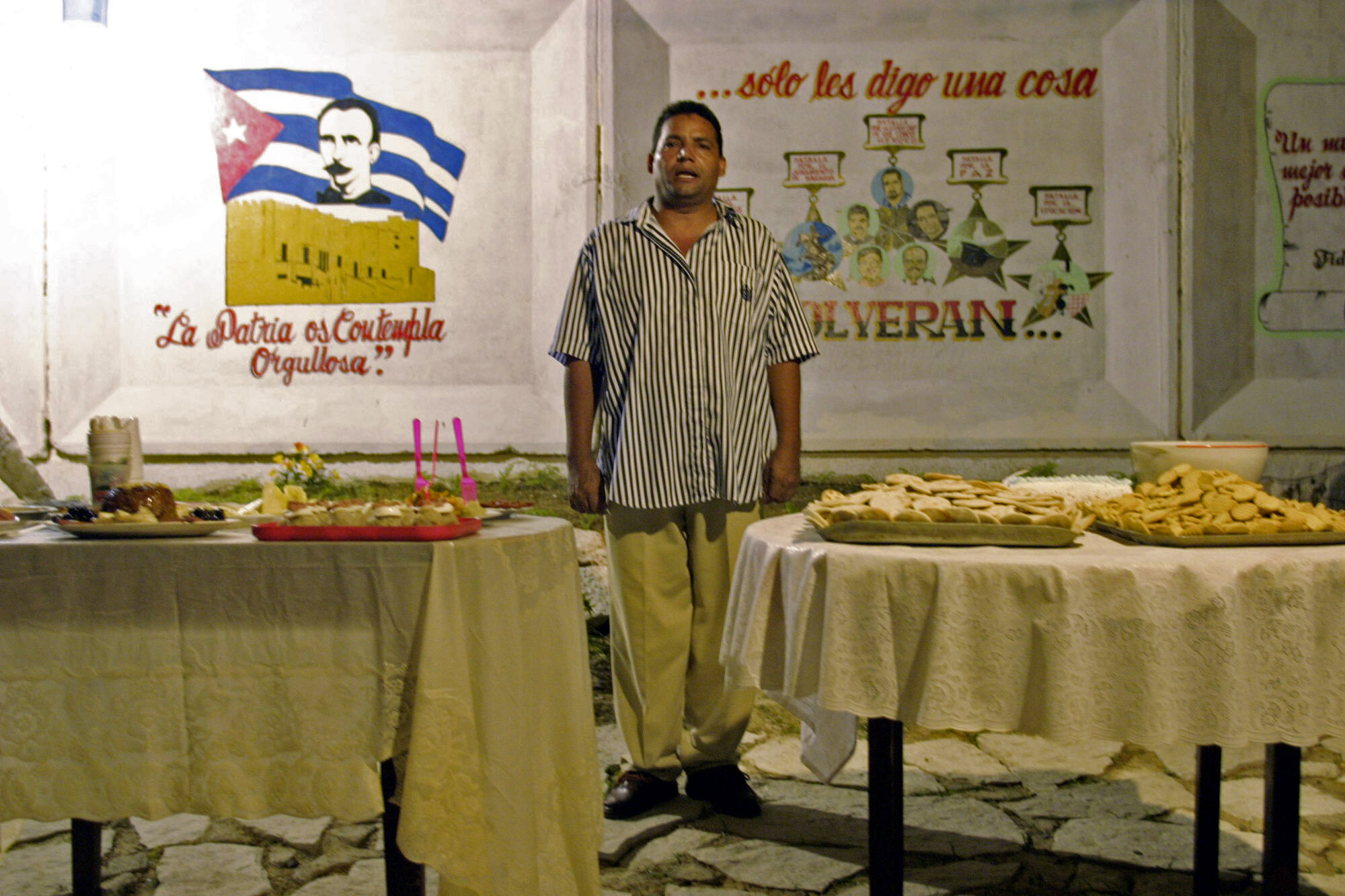  Del Toro, President of the CDR # 1 Ernesto Che Guevara, in Santiago de Cuba, sings the national anthem. 2003.                  