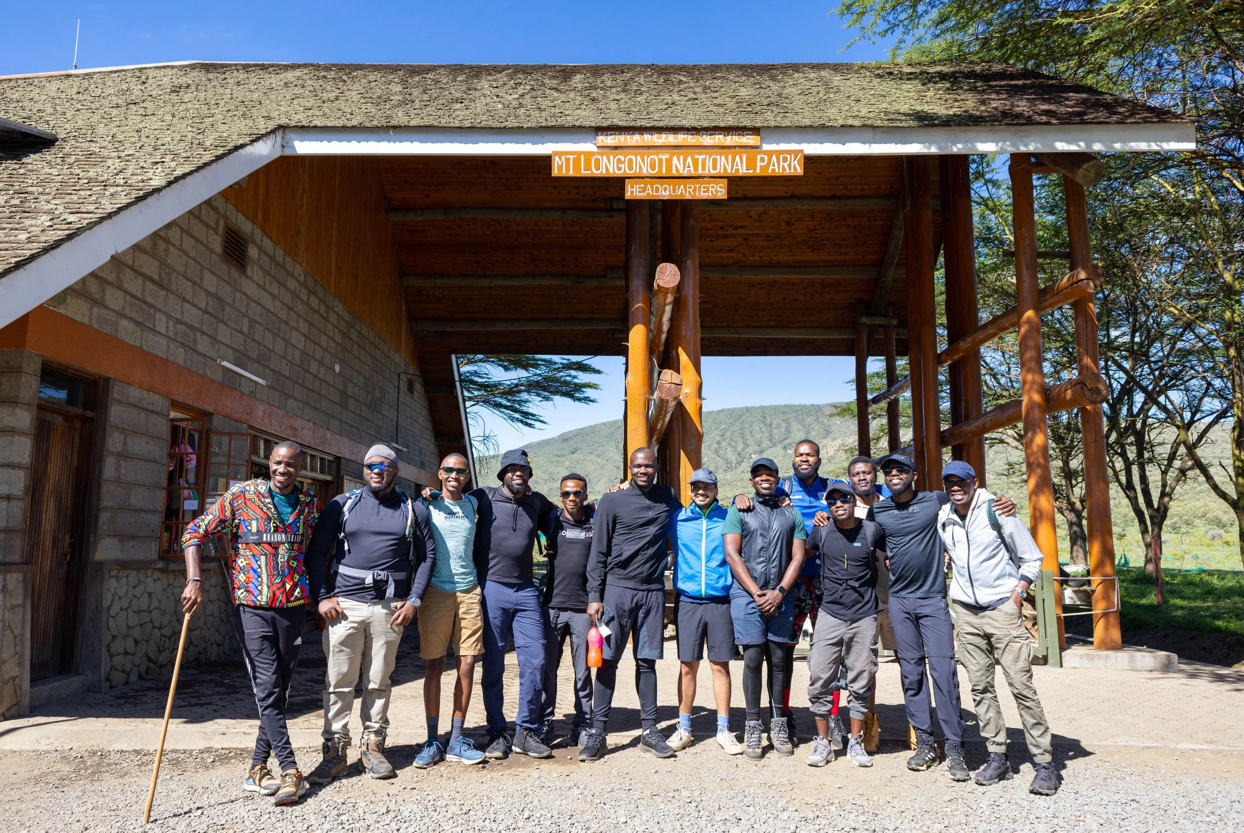 Group of hikers pose for a picture at the entrance to Mt. Longonot National Park