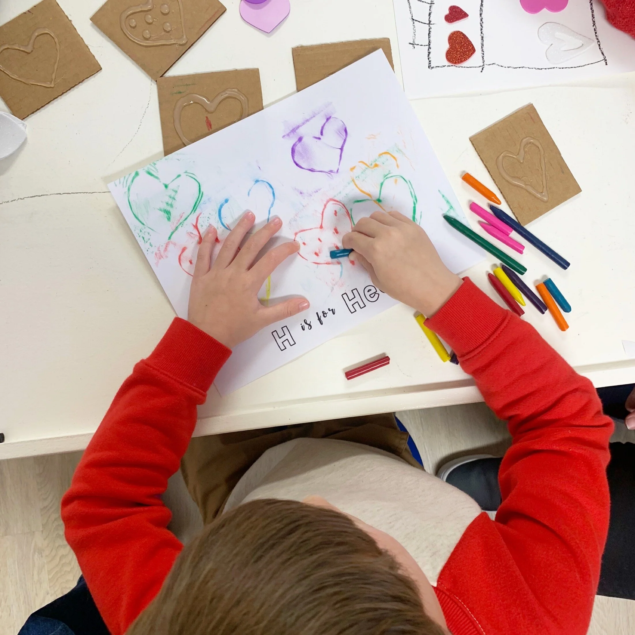 This preschooler has magic coloring changing powers in this picture! Haha Blue crayon in hand, red heart appearing? !