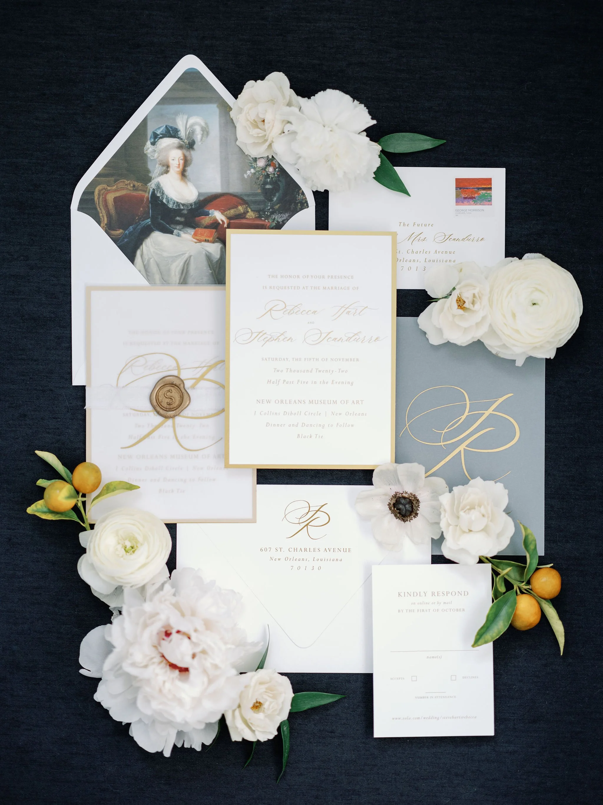 Museum inspired wedding invitation with white flowers, greenery, and a vintage portrait inside an envelope, placed on a black background. Best luxury wedding planner in New Orleans.