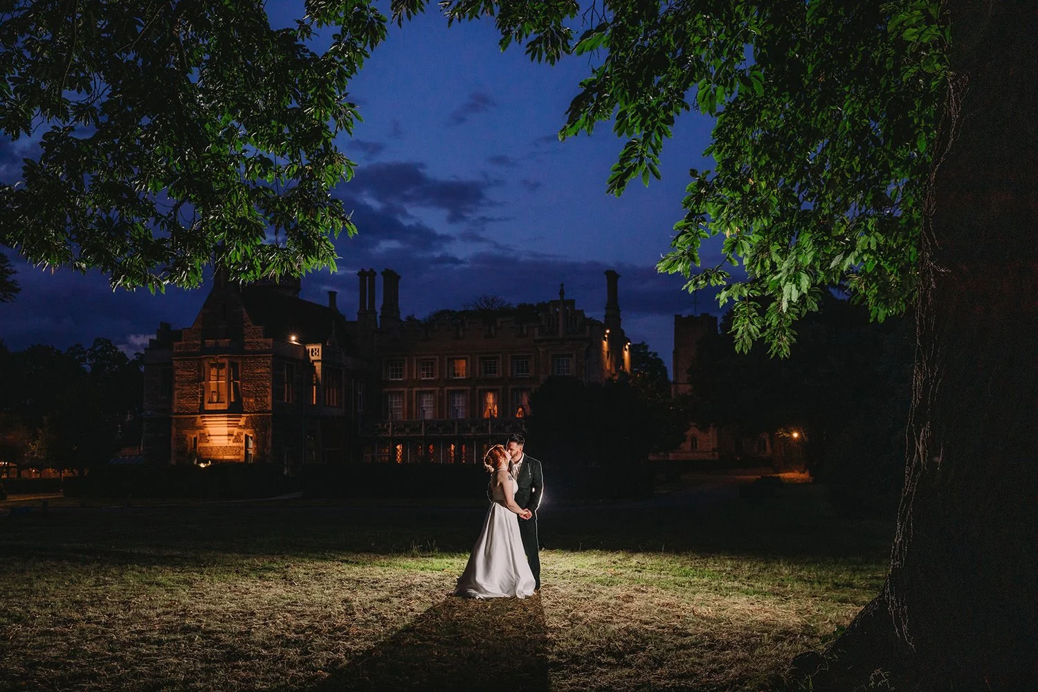 Bride and groom in front of Orton Hall at twilight