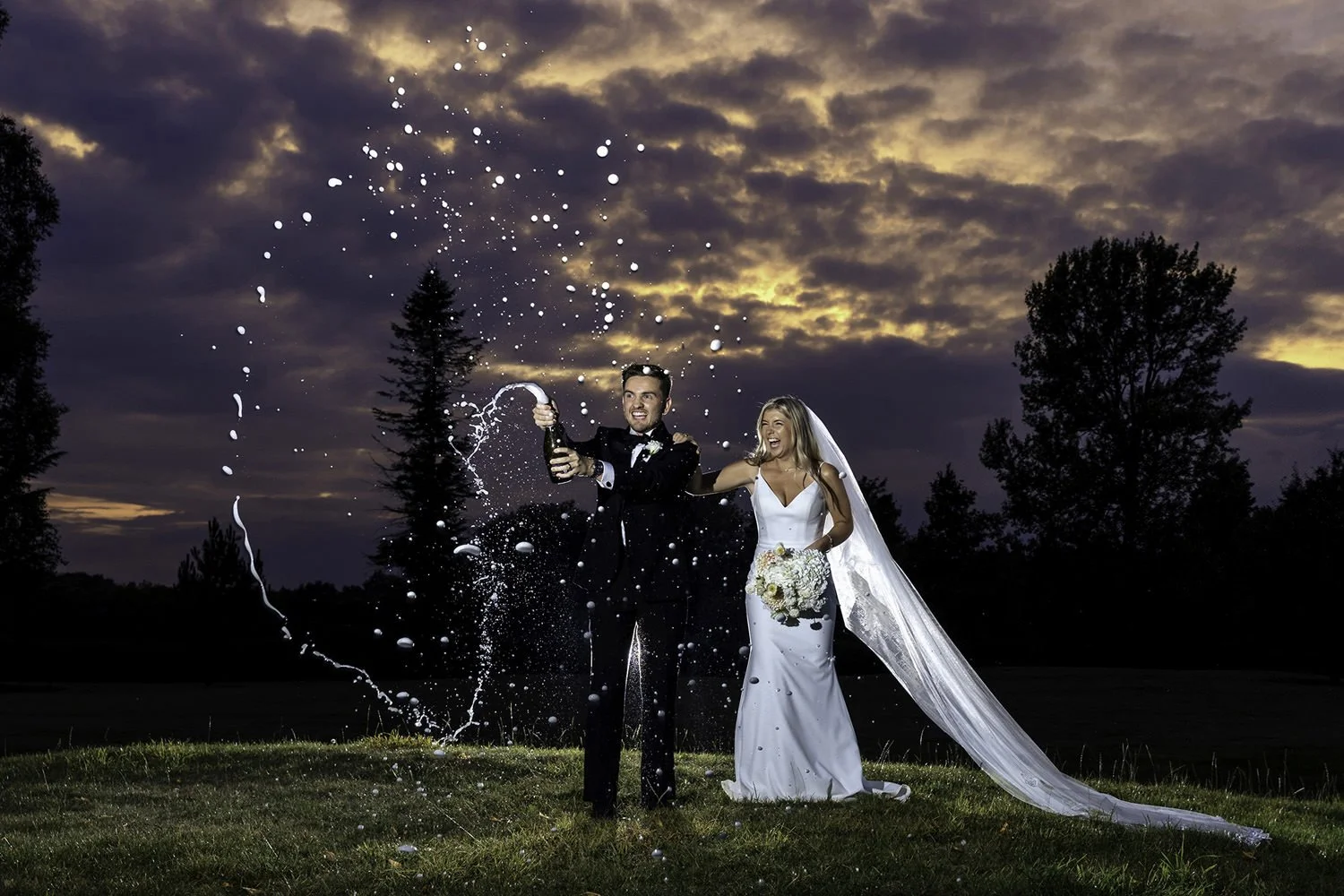 Bride and groom spraying Prosecco