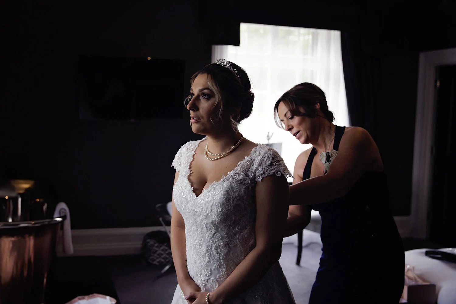 Mum helping put on the wedding dress