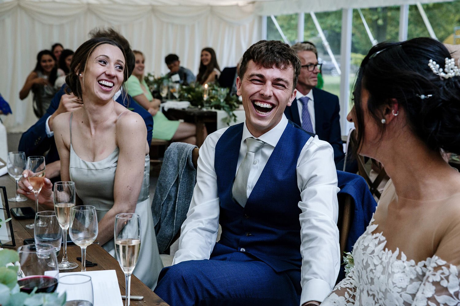 Groom laughing at best man's speech Barrington Hall